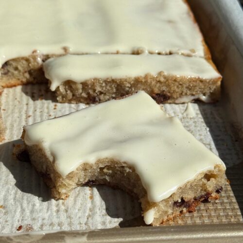 grandma's sheet cake recipe with a cut slice and a bite taken out of it.