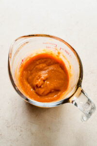 peanut ginger sauce mixed in large measuring cup.