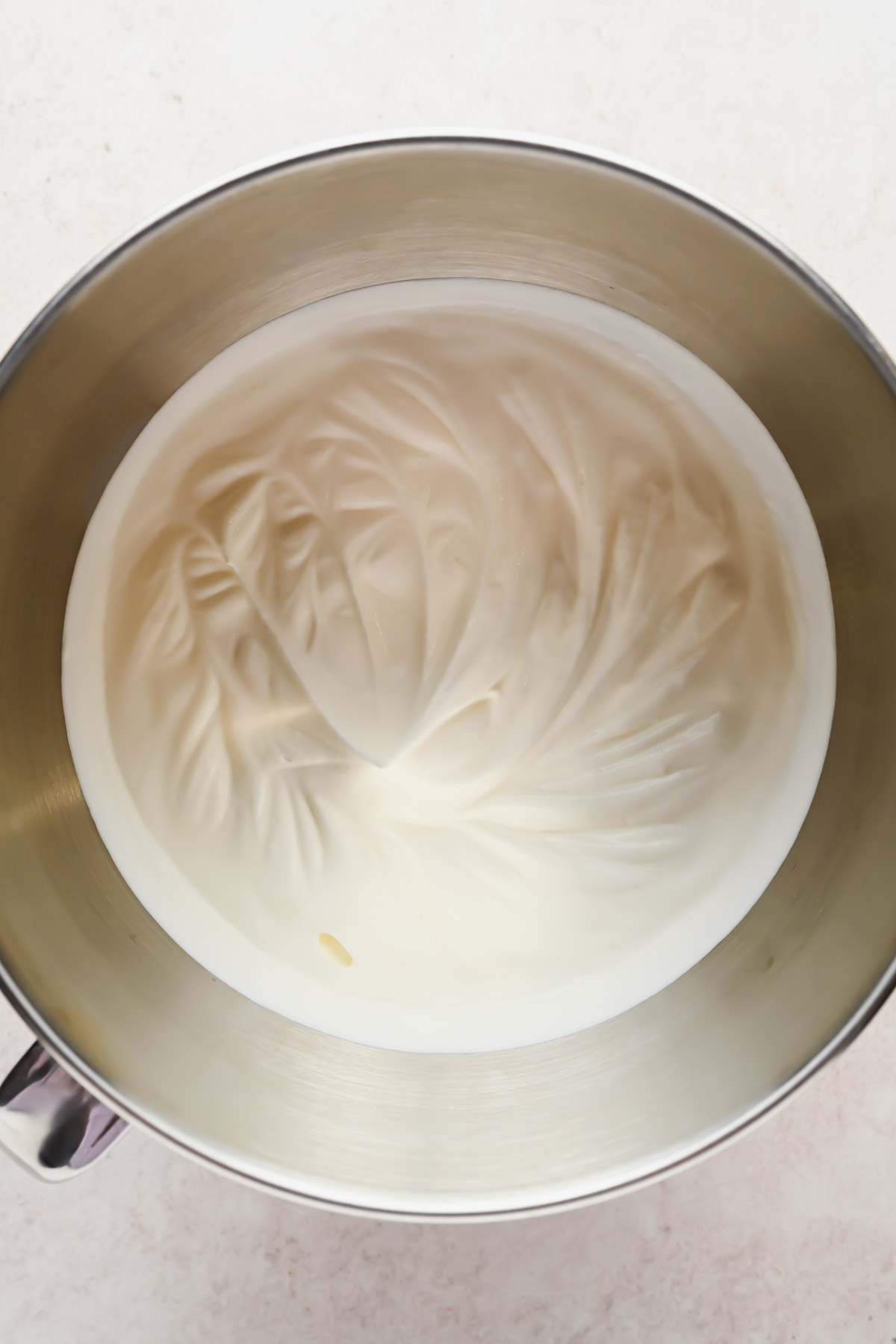 heavy whipping cream whipped in bowl of stand mixer.