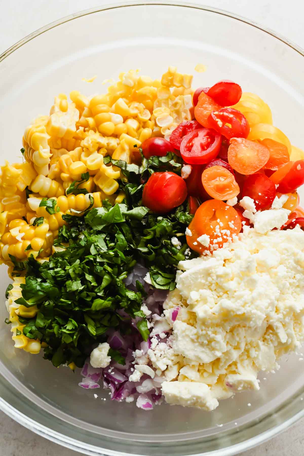 ingredients for corn salsa in large bowl before tossing.