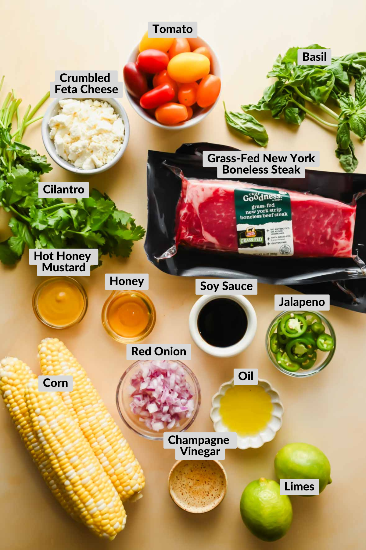 labeled ingredients in individual bowls for steak with corn garnish recipe.