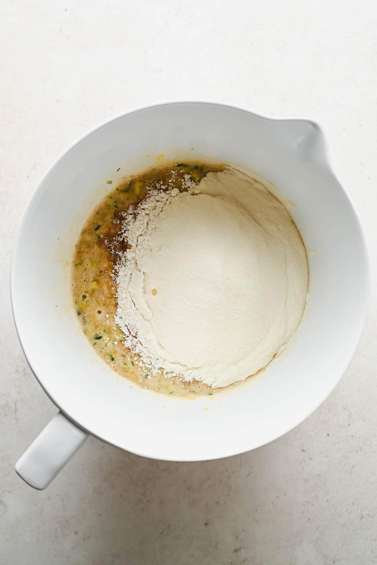 ingredients for protein zucchini muffins in large mixing bowl.
