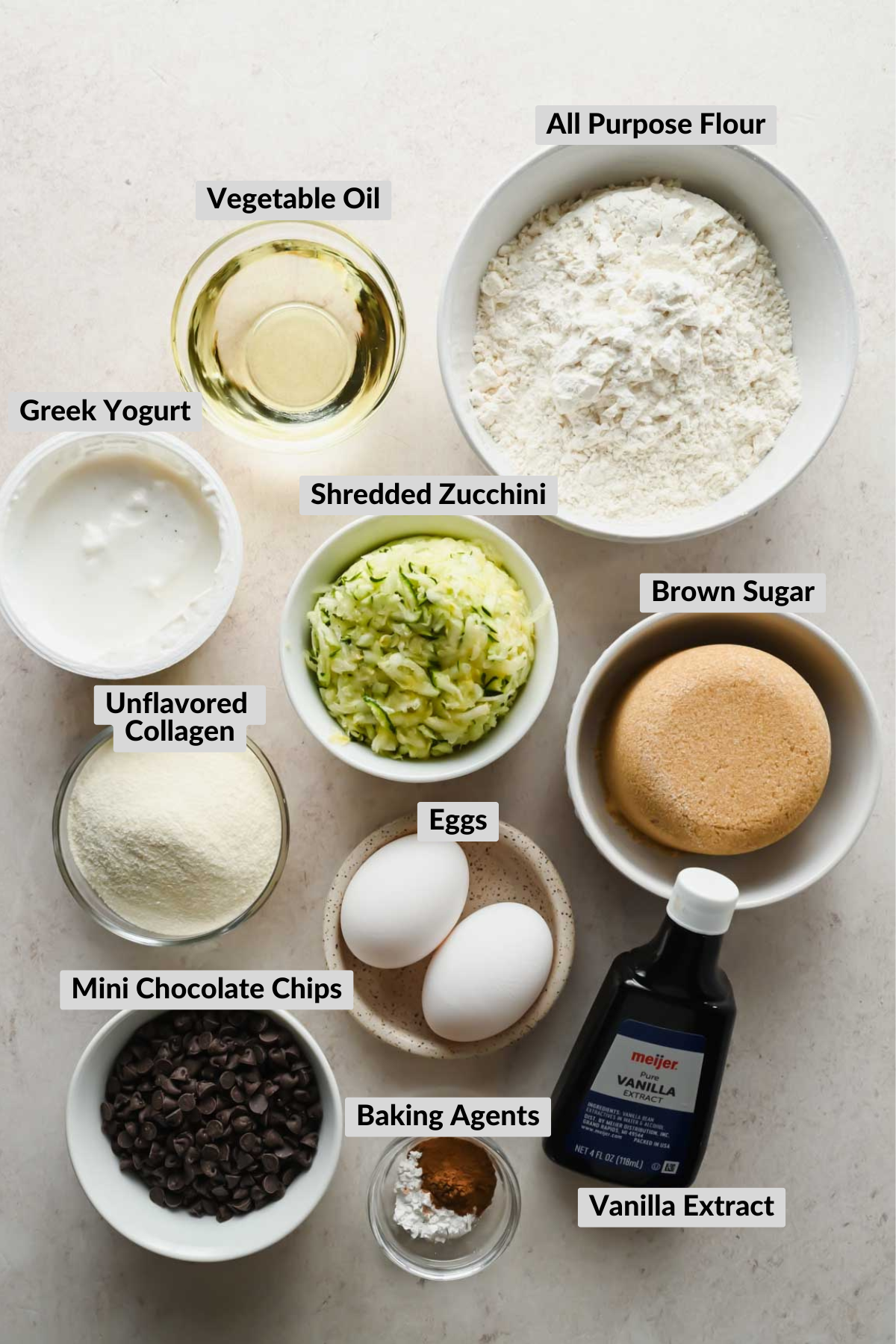 ingredients for protein zucchini muffins in separate bowls.