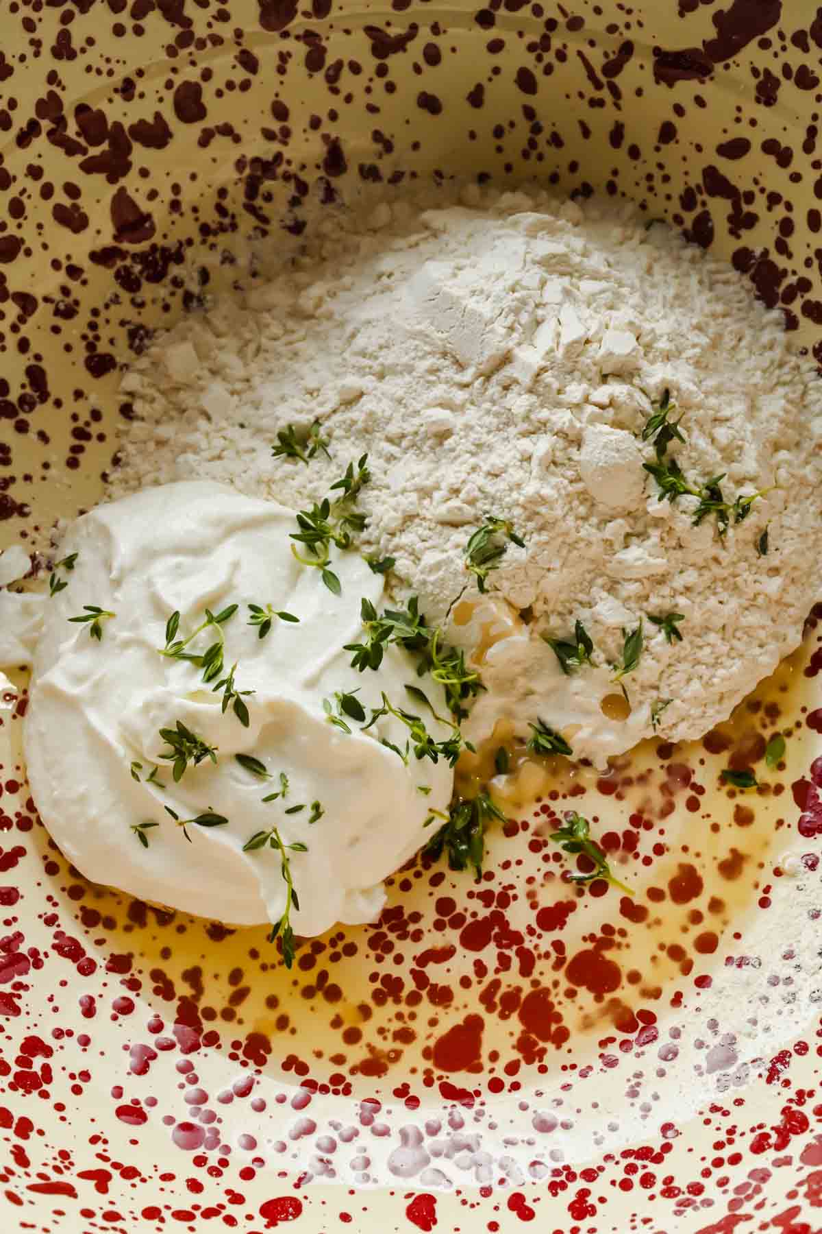 ingredients for cottage cheese biscuit dough in a large speckled mixing bowl.