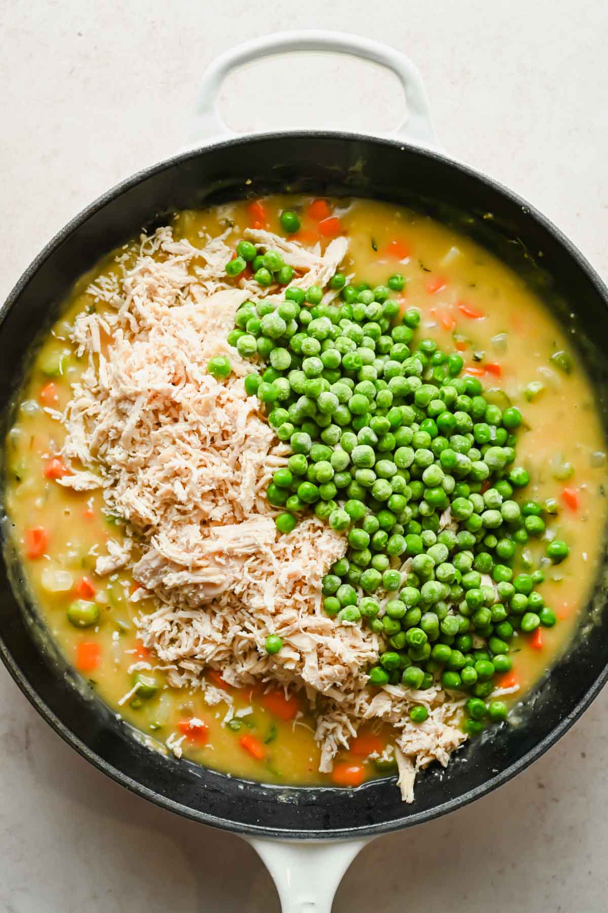 peas and shredded chicken added to brothy vegetable mixture in large skillet.