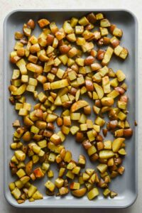 diced roasted potatoes on large sheet pan.