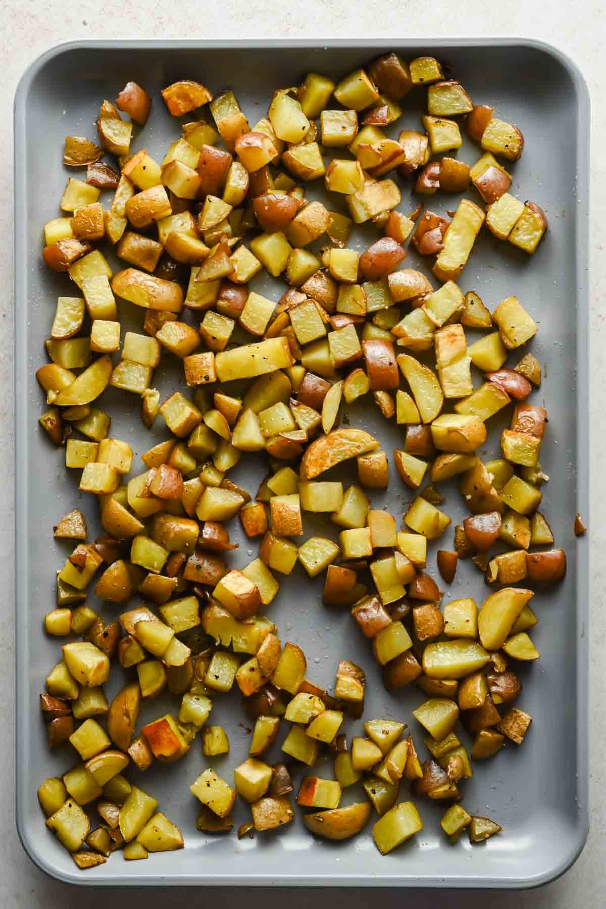 diced roasted potatoes on large sheet pan.
