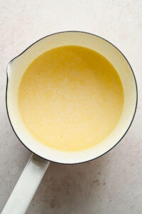 melted cheese sauce in large white sauce pan.