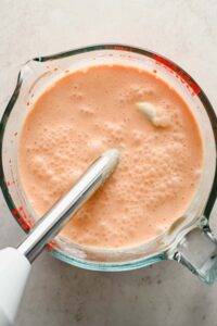 spicy coconut sauce in large pyrex measuring cup.